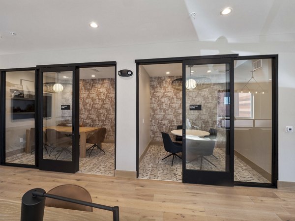 Modern clubhouse with stylish seating and ambient lighting at Origin Apartments