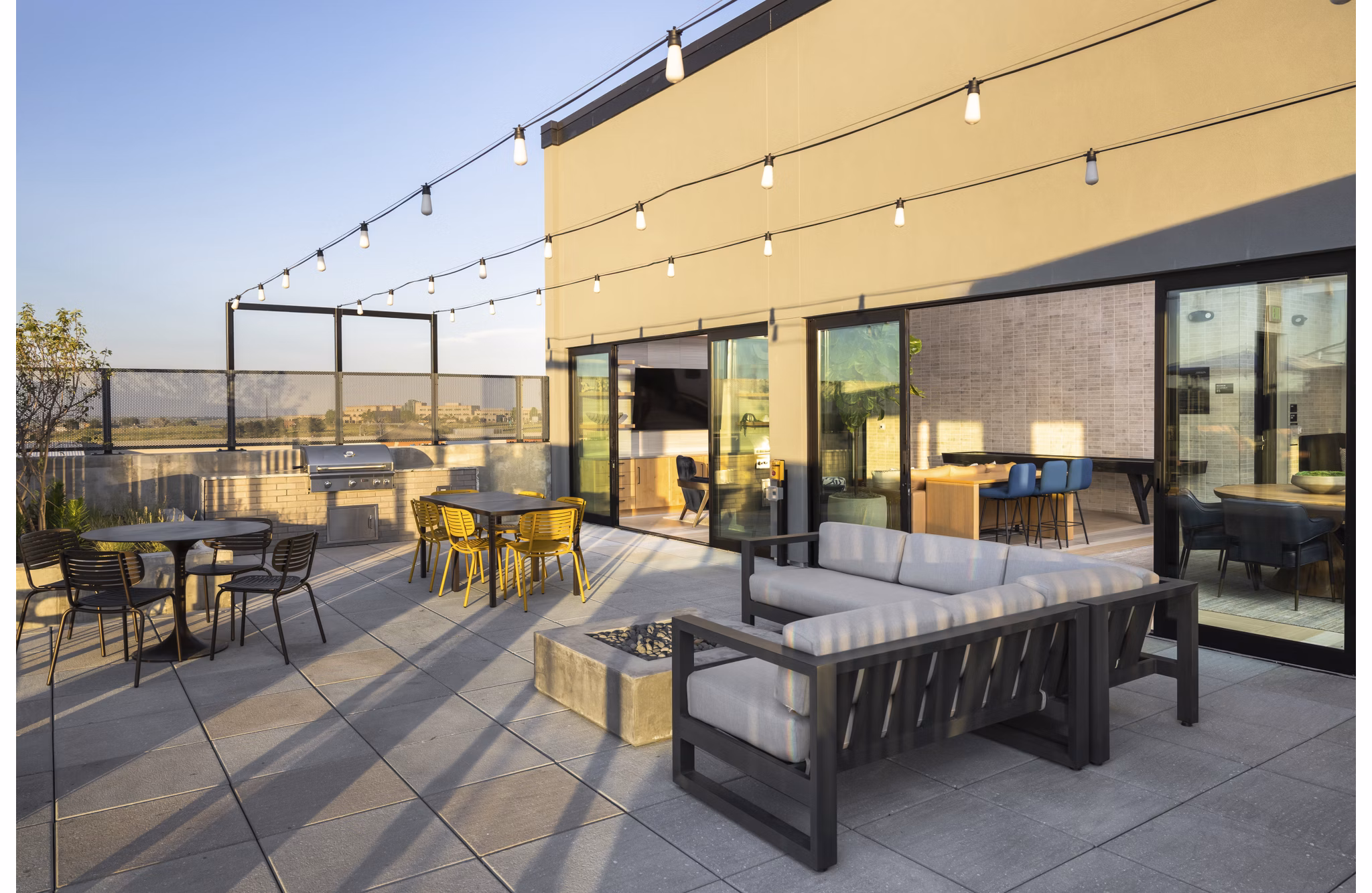 Modern clubhouse featuring a stylish lounge and bar area at Origin Apartments, a Greystar luxury community