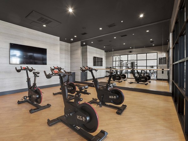 Fitness center equipped with modern machines at Origin Apartments for luxury living