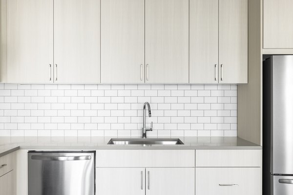 Modern kitchen with stainless steel appliances at Origin Apartments