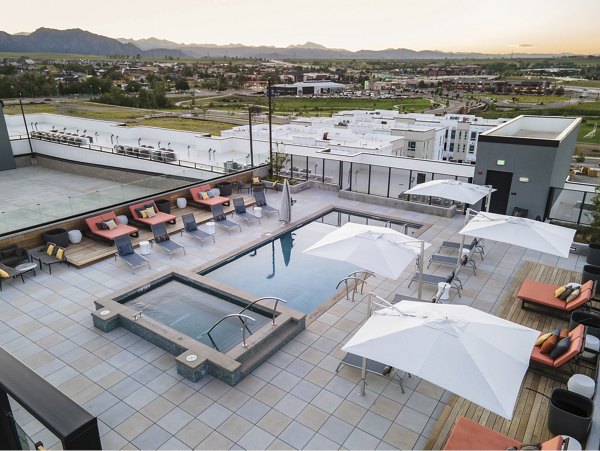 Infinity pool with lounge chairs at Origin Apartments