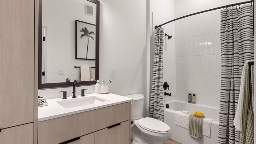 Modern bathroom featuring sleek fixtures and marble countertops at Infield Apartments