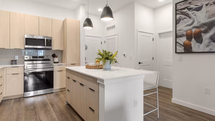 Modern kitchen with sleek appliances and granite countertops in Infield Apartments
