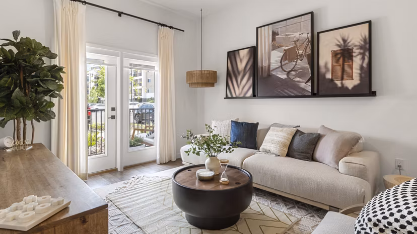 Spacious living room with modern decor and ample natural light at Infield Apartments