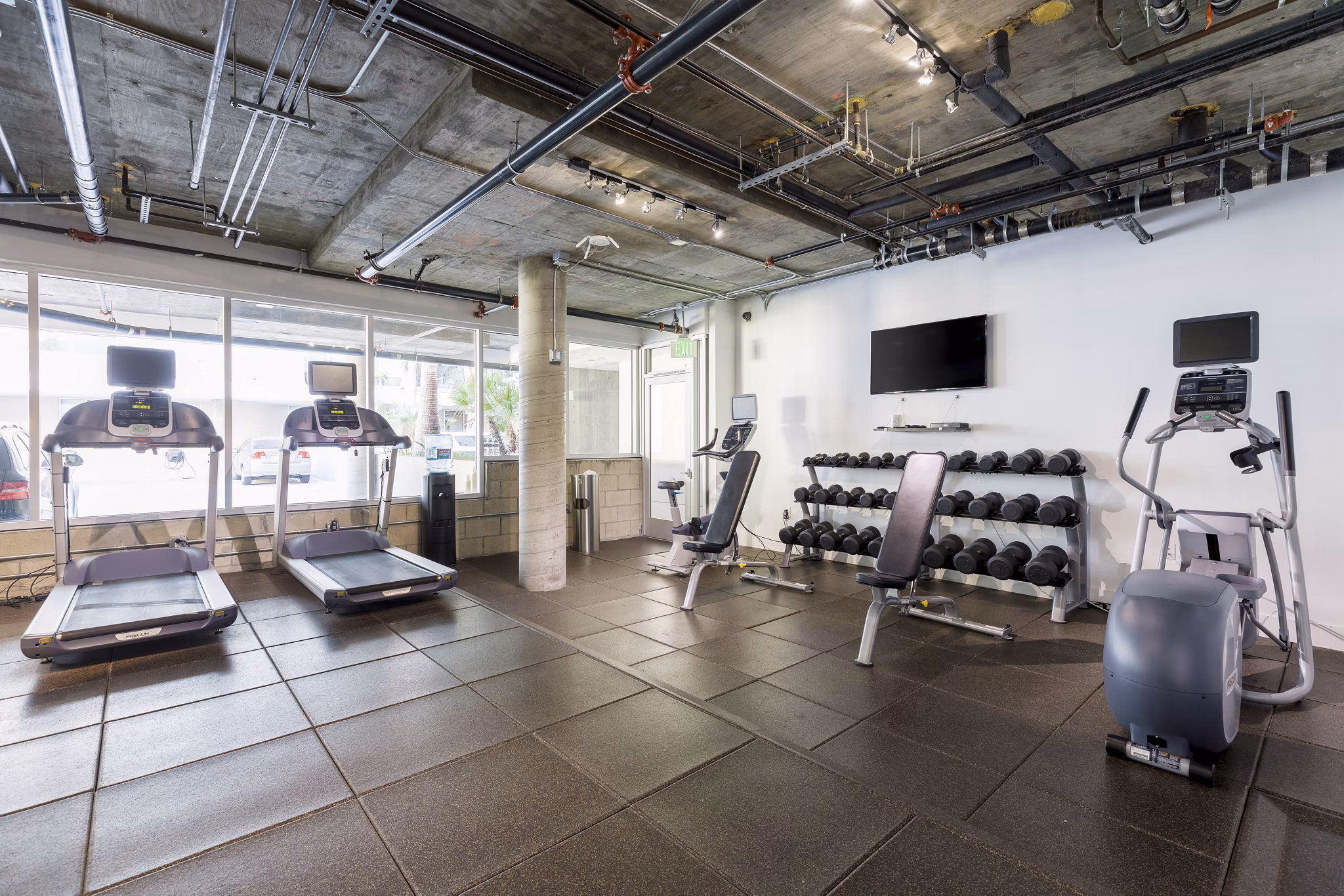 Fitness center featuring modern equipment at The LC Apartments