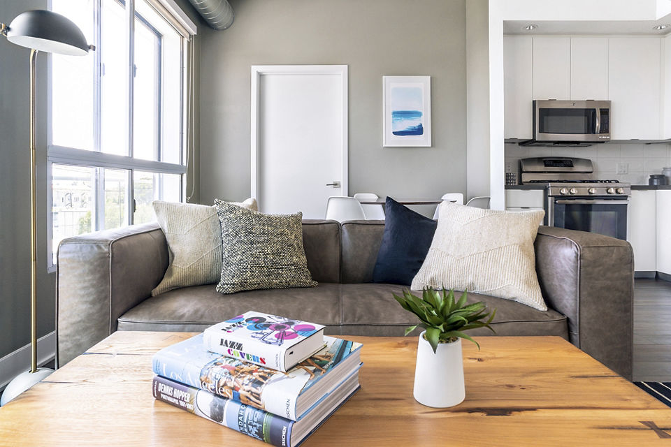 Inviting living room with contemporary decor and large windows at The LC Apartments