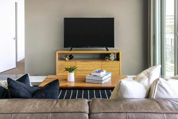 Spacious living room with modern decor and ample natural light at The LC Apartments