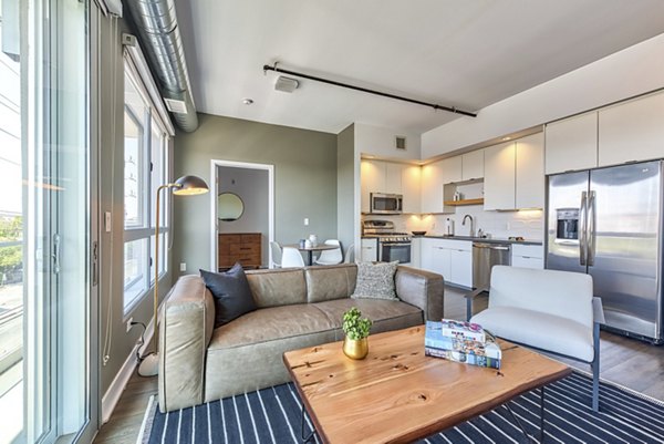 Modern living room with chic furnishings and large windows at The LC Apartments, a luxury residence