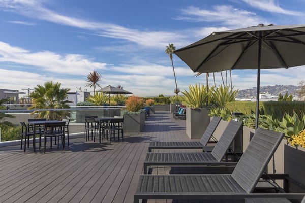 Tranquil courtyard with modern seating and lush landscaping at The LC Apartments