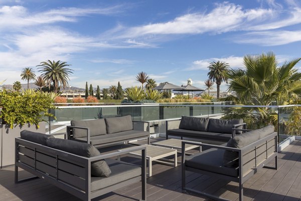 The LC Apartments: Tranquil courtyard with lush greenery and seating areas