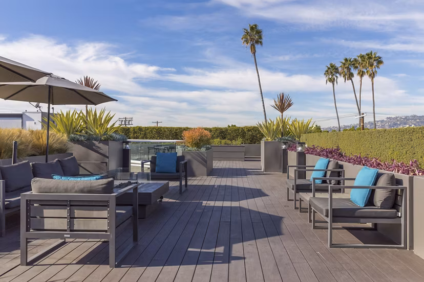 The LC Apartments: Serene courtyard with lush greenery and seating areas