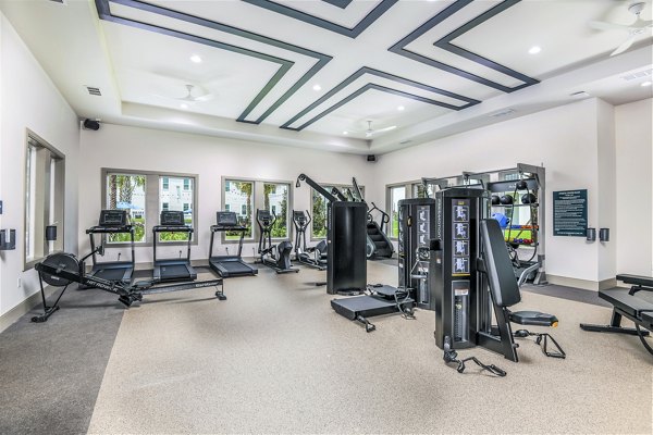 Cutting-edge fitness center at Ltd Champions Ridge Apartments featuring modern equipment and spacious workout areas