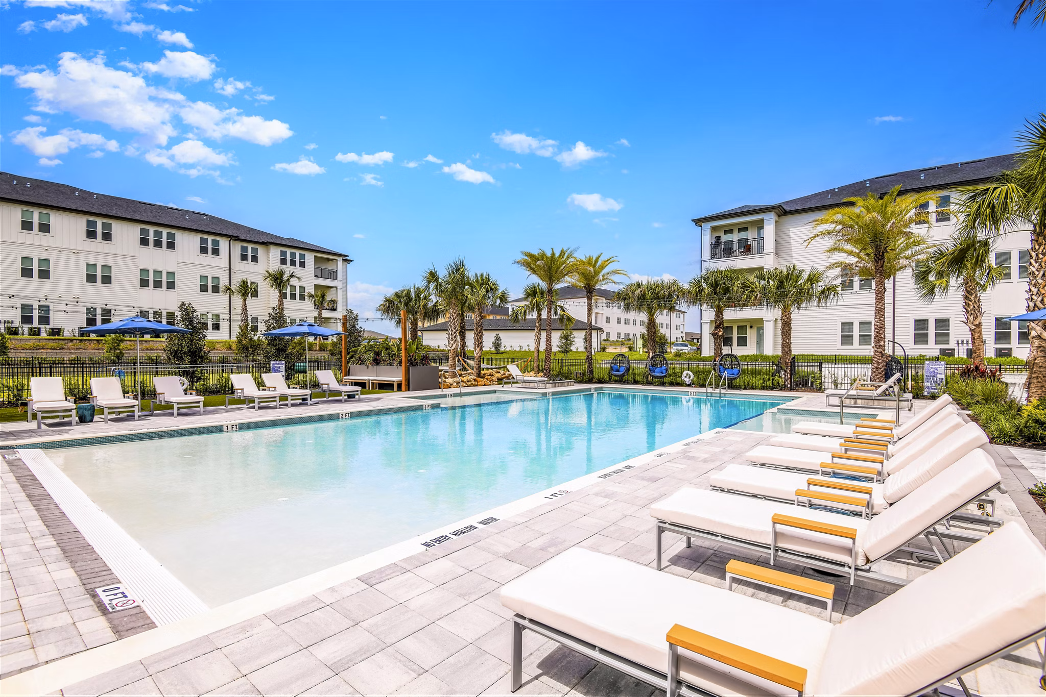 Saltwater pool with sundeck at Ltd Champions Ridge Apartments, a Greystar luxury community