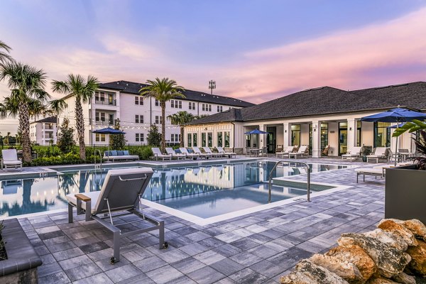 Luxurious pool area with sun loungers at Ltd Champions Ridge Apartments â€“ perfect for relaxation and leisure