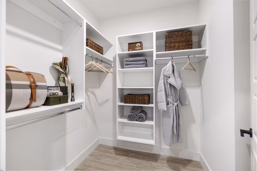 Walk-in closet with built-in shelving at Elev8 Apartments offering ample storage space