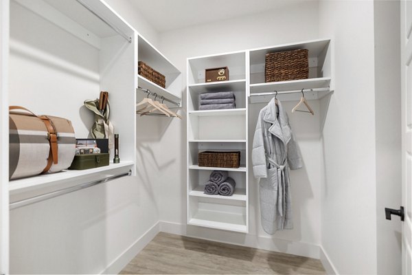 Walk-in closet with built-in shelving at Elev8 Apartments offering ample storage space