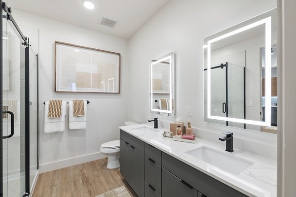 Modern bathroom featuring sleek fixtures and spacious layout at Elev8 Apartments