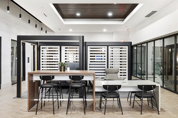 Modern clubhouse featuring open seating and games at Elev8 Apartments in luxury housing community