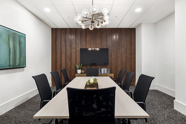 Modern meeting facility with conference table and seating at Elev8 Apartments