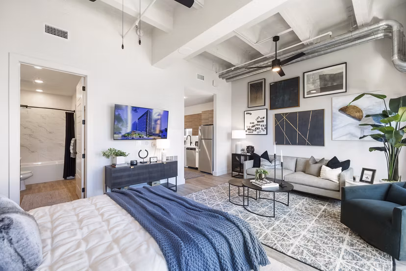 Modern kitchen with stainless steel appliances in Elev8 Apartments