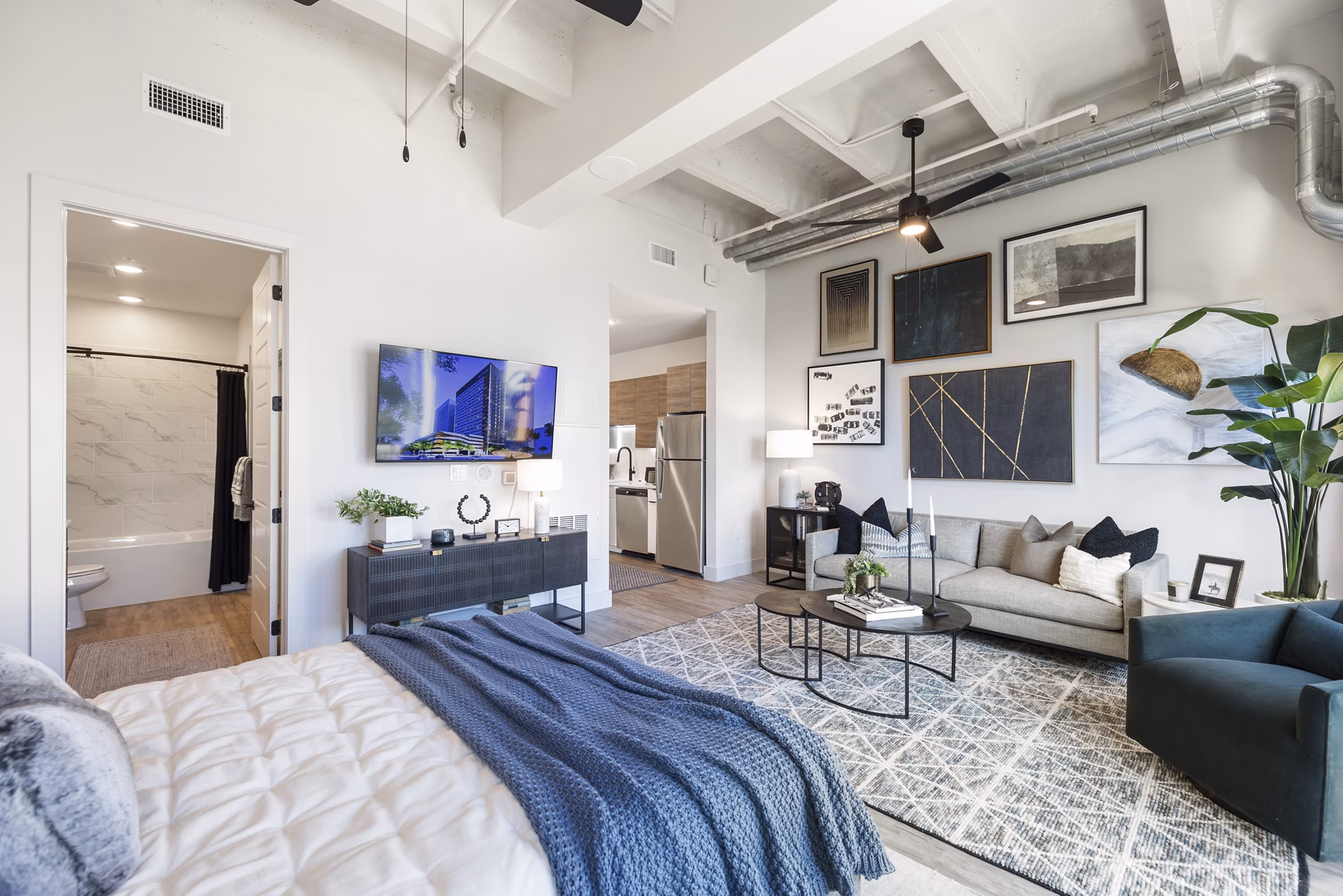 Modern kitchen with stainless steel appliances in Elev8 Apartments