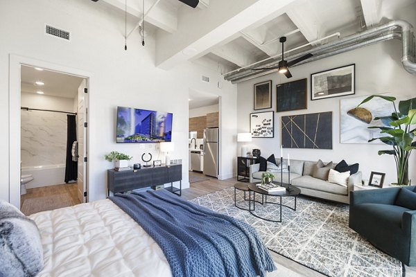 Modern kitchen with stainless steel appliances in Elev8 Apartments