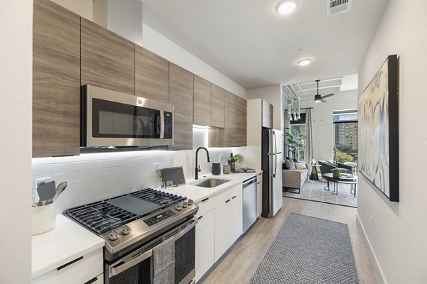 Modern kitchen with stainless steel appliances at Elev8 Apartments