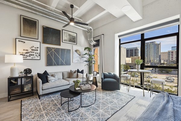 Elegant living room with modern decor and large windows at Elev8 Apartments in Greystar's luxury development