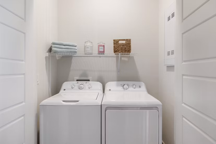 Laundry room with modern appliances in Elev8 Apartments, luxury living by Greystar