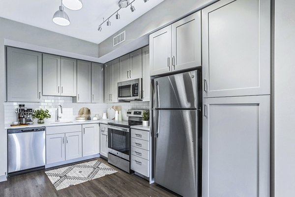 Modern kitchen with stainless steel appliances at Vista Fairfax Corner Apartments