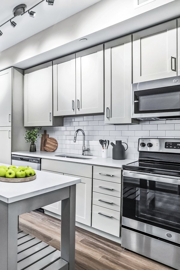 Modern kitchen with stainless steel appliances at Vista Fairfax Corner Apartments