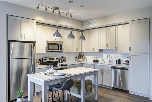 Modern kitchen with stainless steel appliances at Vista Fairfax Corner Apartments
