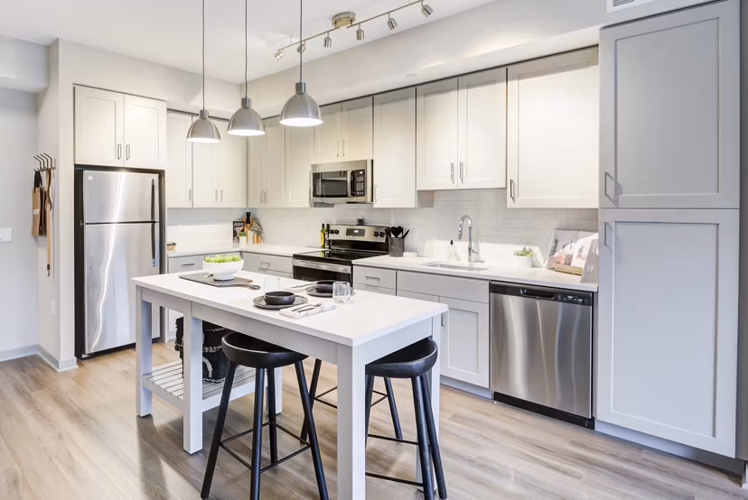Modern kitchen with stainless steel appliances in Vista Fairfax Corner Apartments
