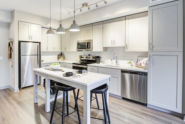 Modern kitchen with stainless steel appliances in Vista Fairfax Corner Apartments