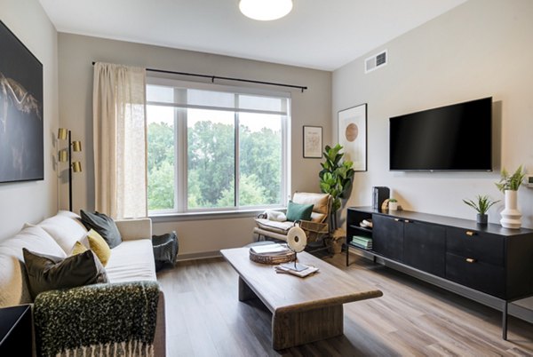 Contemporary living room with plush seating and large windows at Vista Fairfax Corner Apartments