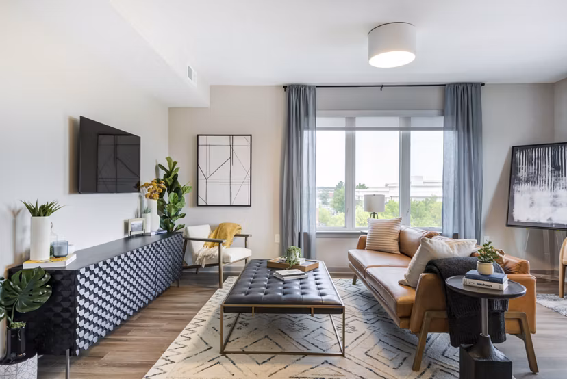 Spacious living room with modern decor and natural light in Vista Fairfax Corner Apartments