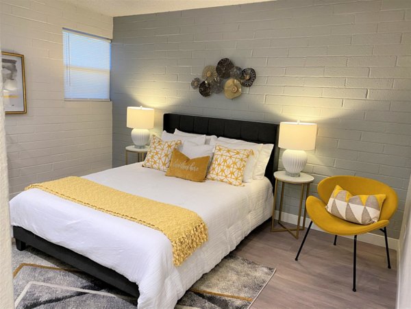 Cozy bedroom featuring modern furnishings at Seventh Apartments