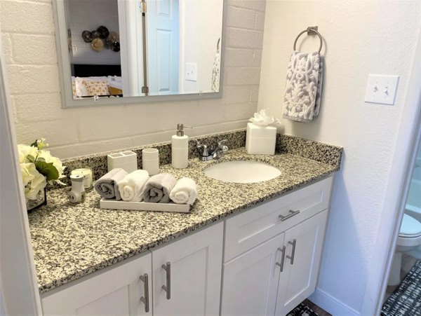Sleek bathroom with marble countertops at Seventh Apartments luxury residences