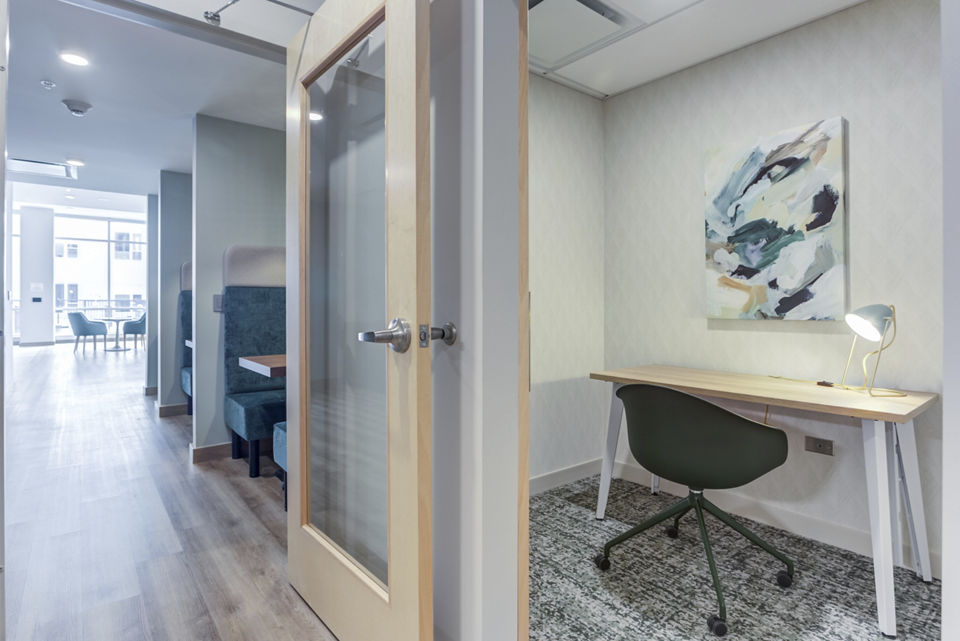 Clubhouse featuring modern interiors at DASH Downers Grove Apartments, a luxury property by Greystar