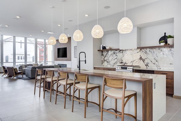 Clubhouse featuring modern seating and entertainment areas at DASH Downers Grove Apartments