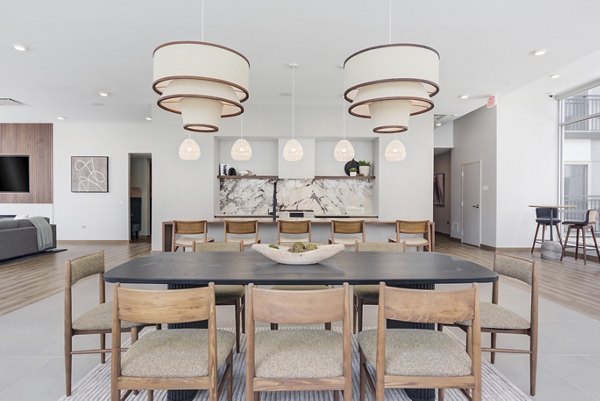 Clubhouse featuring modern design and entertainment amenities at DASH Downers Grove Apartments