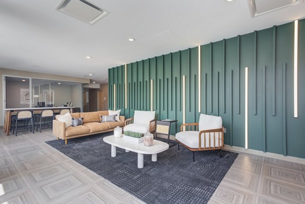 Clubhouse at DASH Downers Grove Apartments featuring modern design and community seating areas for leisure and events