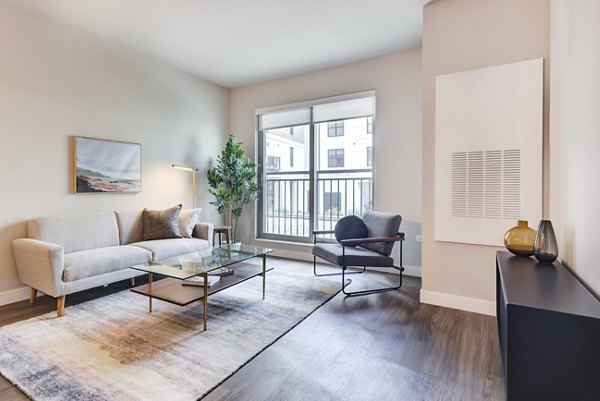 Spacious living room with modern decor at DASH Downers Grove Apartments