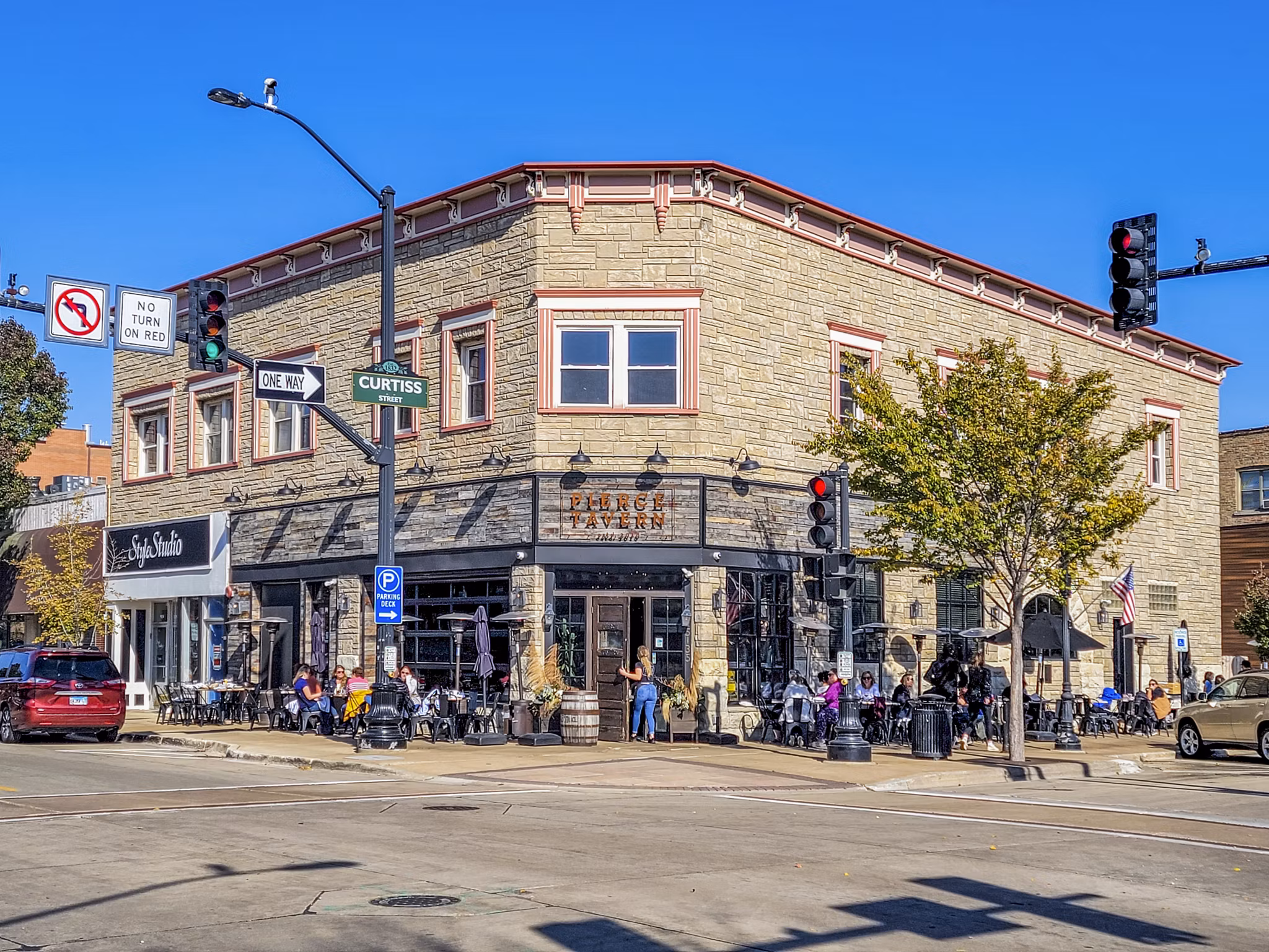 Neighborhood street view near DASH Downers Grove Apartments, showcasing local shops and tree-lined walkways Ideal for city-savvy residents