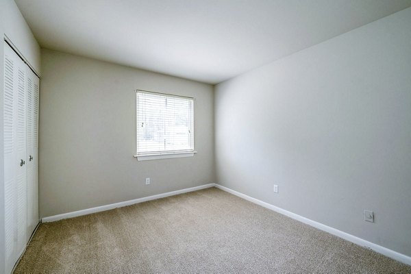Spacious bedroom with modern decor in Woodshire Apartments, luxury living in Greystar community