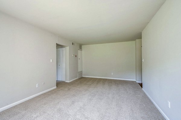 Cozy bedroom with modern decor at Woodshire Apartments, featuring neutral tones and spacious layout for comfort and relaxation