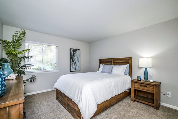 Cozy bedroom with contemporary decor in Woodshire Apartments