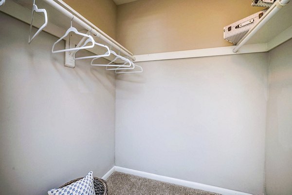 Woodshire Apartments: Walk-in closet with adjustable shelves and ample storage space in a luxury bedroom