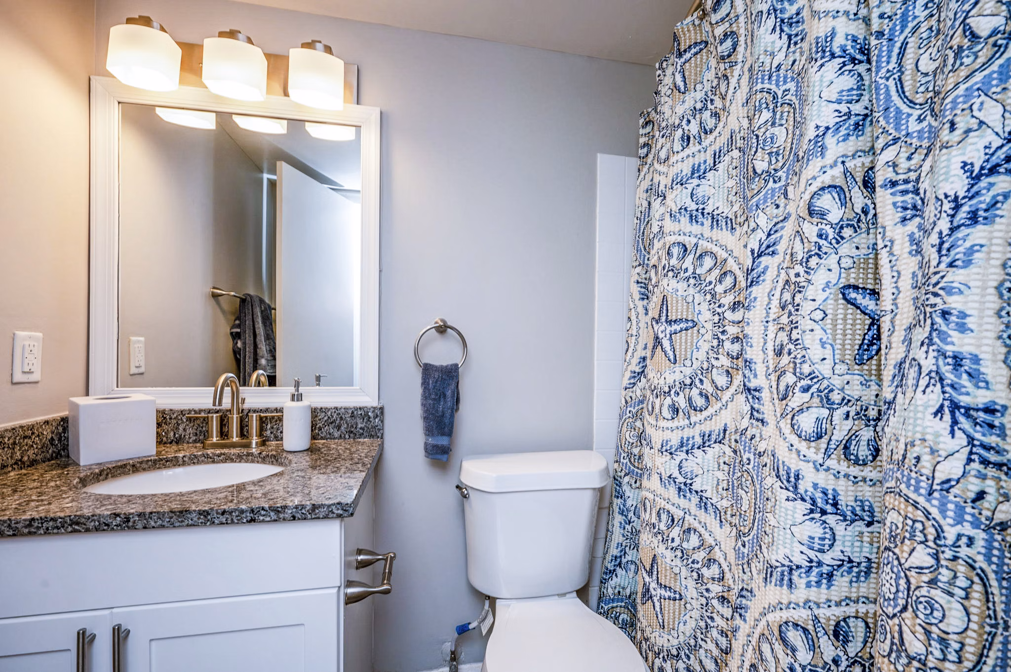 Cozy bedroom featuring elegant decor and ample natural light in Woodshire Apartments