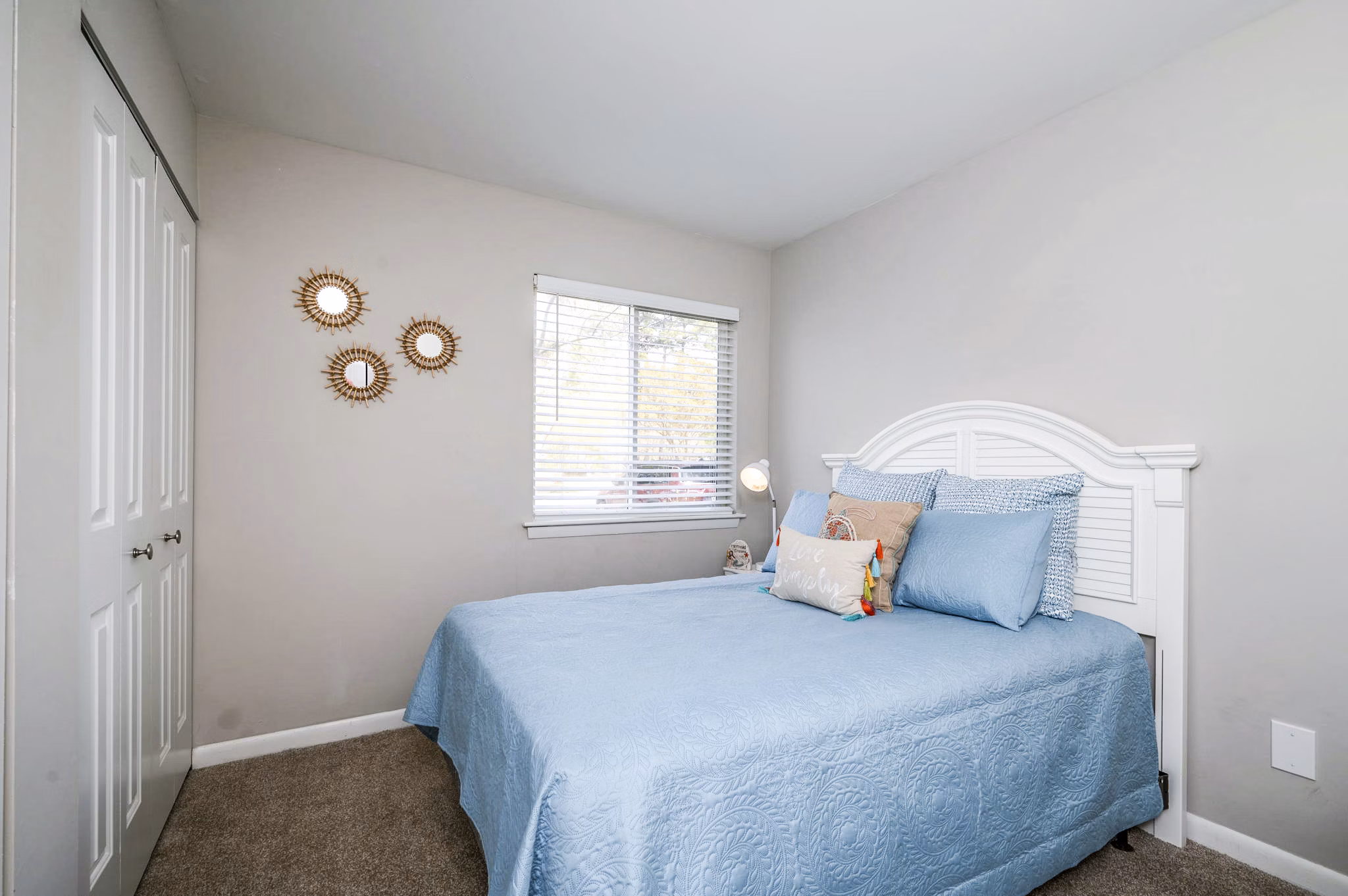 Woodshire Apartments: Cozy bedroom with stylish decor and natural light